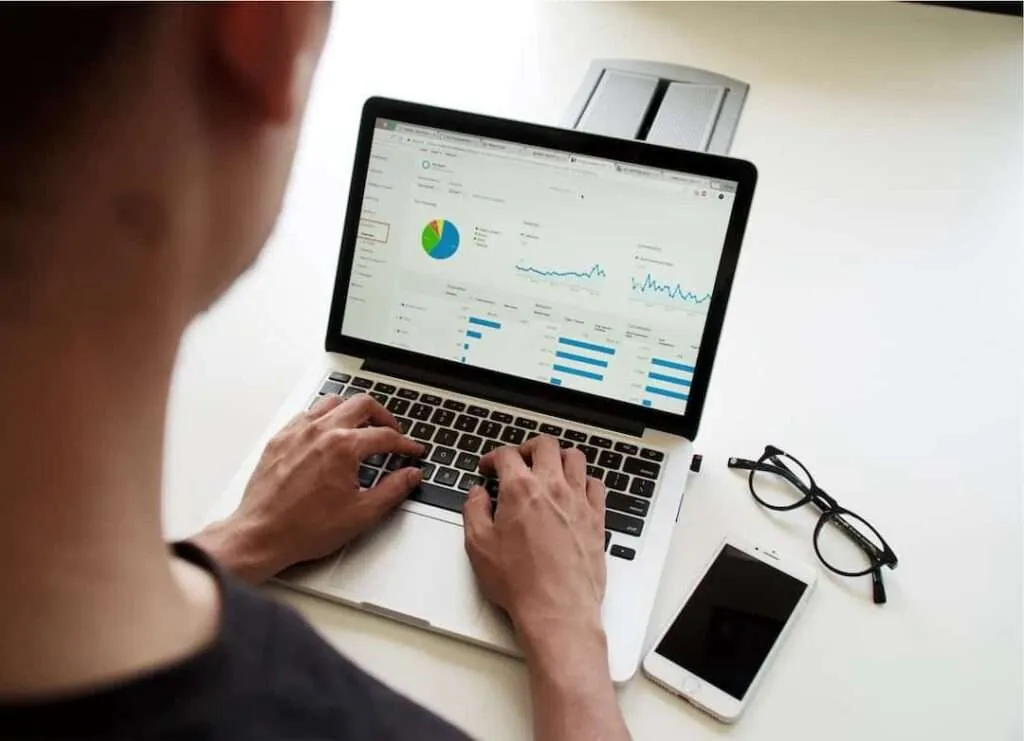 Person analyses statistics on laptop screen.